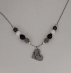 Celebrate identity with this demisexual pride necklace. Silver-plated, nickel-free stainless steel with a heart pendant engraved “Fight for the Fairytale.” Adjustable 18–20 inches.