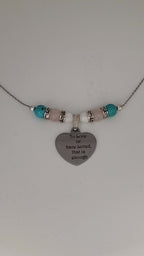 Premium transgender pride necklace featuring blue magnesite, rose quartz, and mother of pearl. Nickel-free, plastic-free, silver-plated stainless steel with engraved heart pendant.