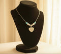 Premium transgender pride necklace featuring blue magnesite, rose quartz, and mother of pearl. Nickel-free, plastic-free, silver-plated stainless steel with engraved heart pendant.